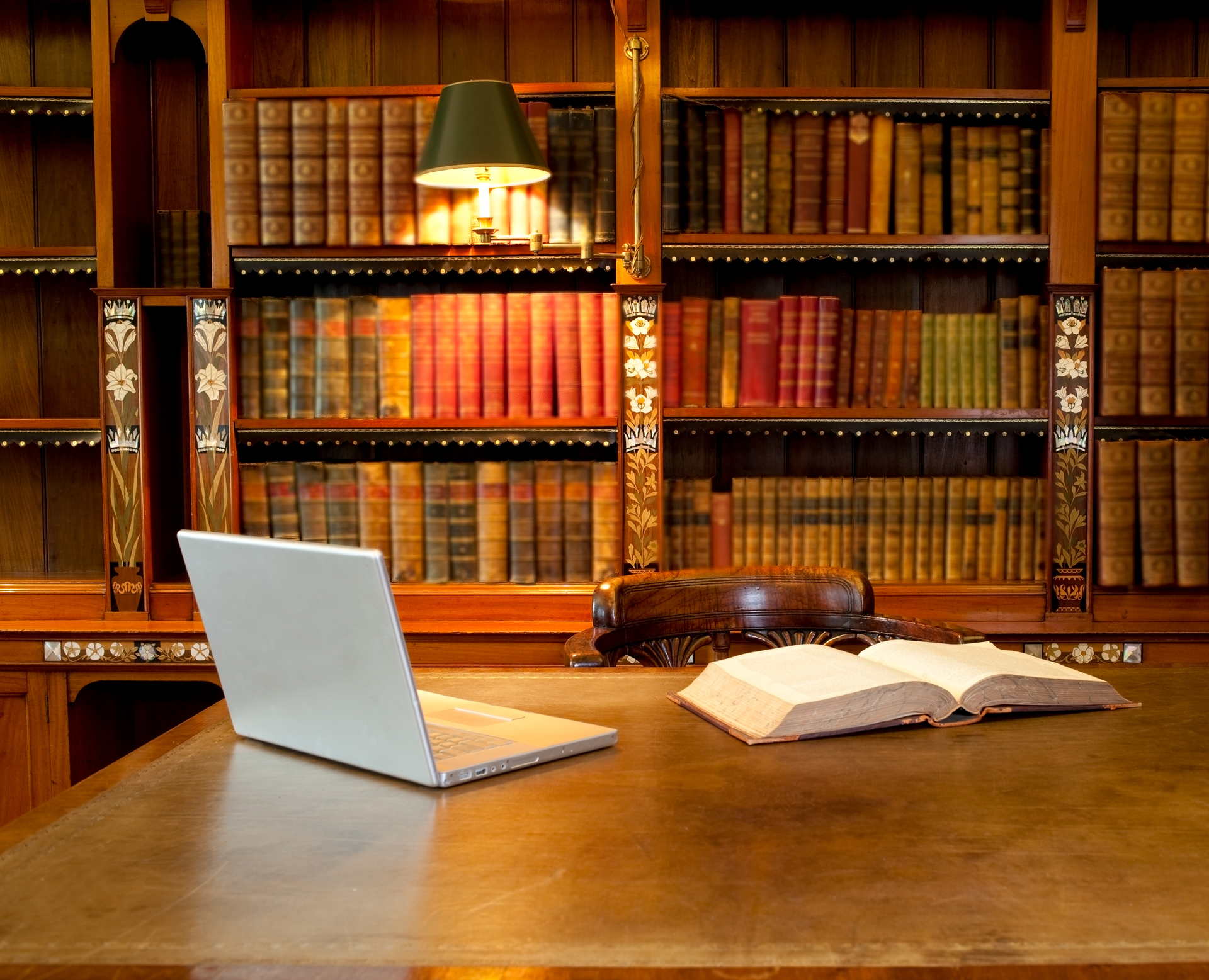 laptop and book in law school library at empty desk